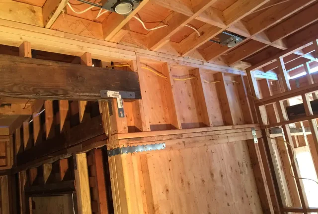 New electrical wiring run through open wall framing during a remodel by Tamar Electric